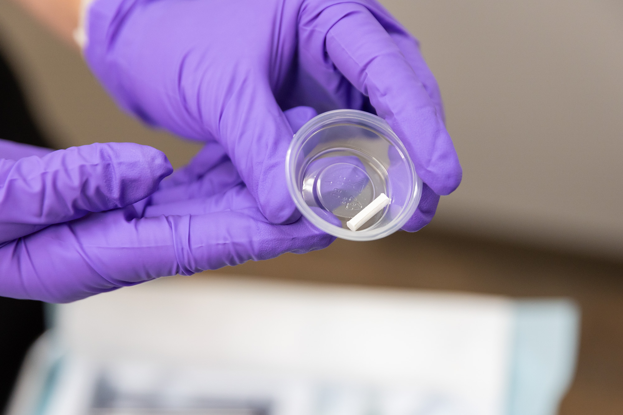 A provider, wearing surgical gloves, shows the pellet used in hormone replacement therapy in Southlake. The pellets are roughly the size of a grain of rice, and are inserted under the skin. 