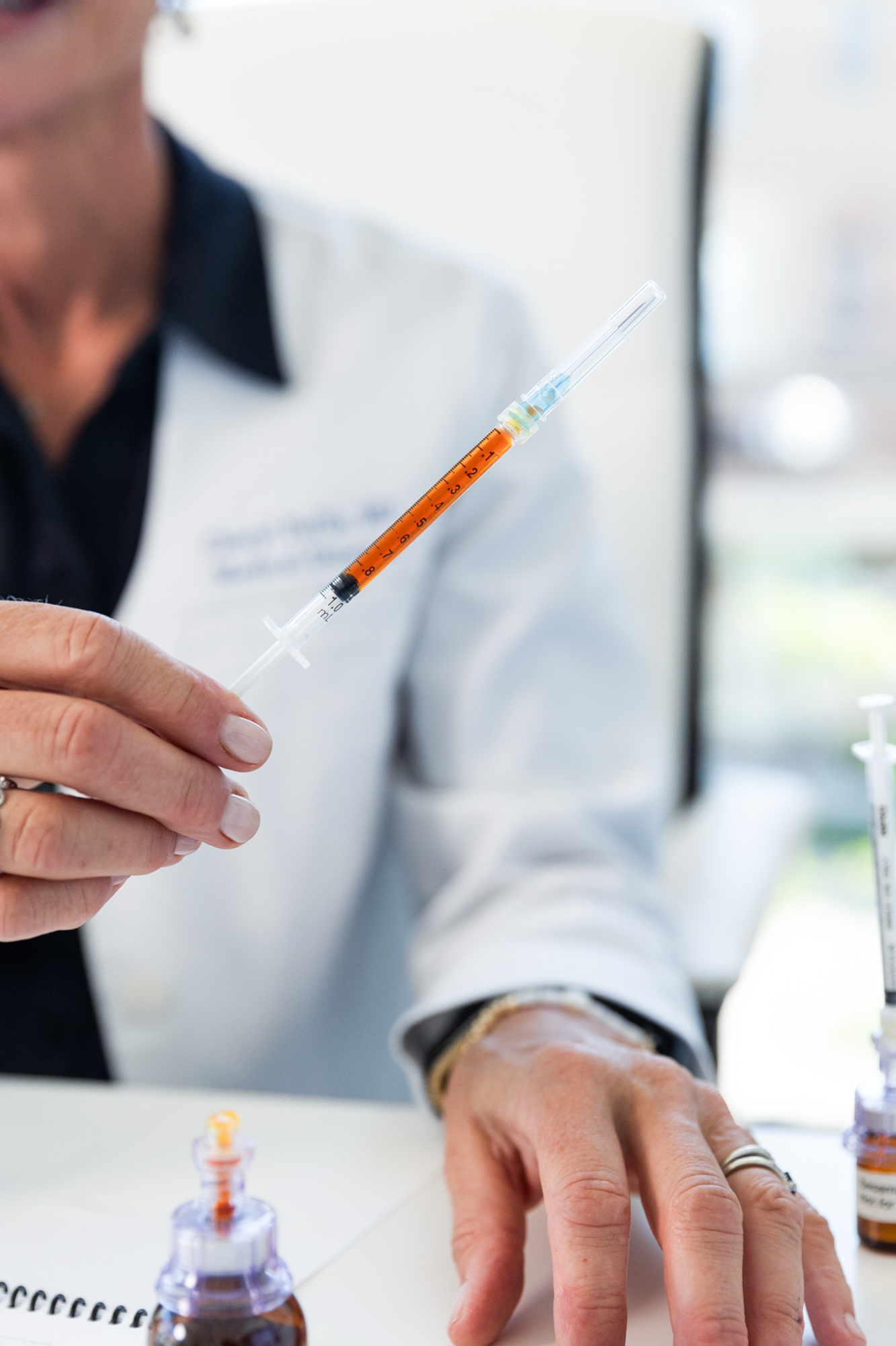 A provider at Dynamic Life Health Center holds a vitamin shot in Southlake, TX.